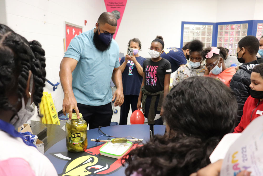 At STEAM Day, Mychal Smith, Ph.D., an assistant professor of chemistry at VCU, turns a pickle into a battery for fifth-graders at Patrick Copeland Elementary School in Hopewell. VCU students and faculty volunteered on the first day of spring break to teach grade-school students about science, technology, engineering, the arts and math. (Alexis Finc, VCU College of Humanities and Sciences)