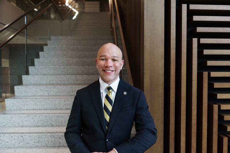 Stephan Davis standing at the bottom of the College of Health Professions stairway.