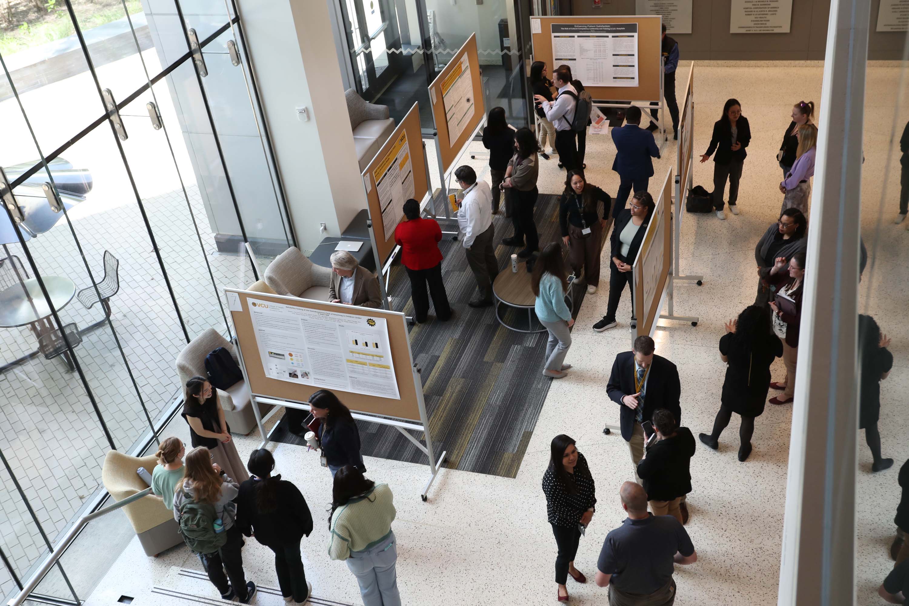 CHP lobby crowded during research week and filled with research posters