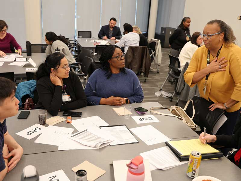 Audrey Roberson, Ph.D., RN, CPAN, NPD-BC interacts with students during the simulation.