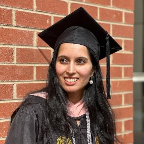 Poonamdeep Bajwa in graduation gown and cap