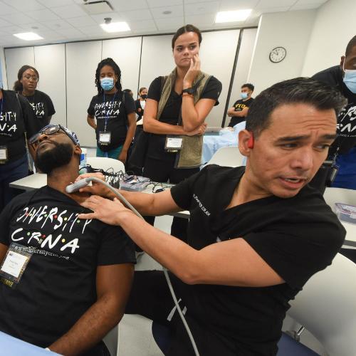 Group of students watch ultrasound demonstration.