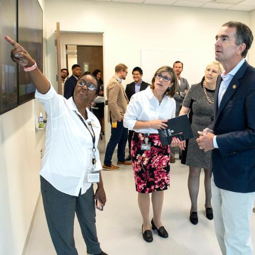 (From left) Beverly George-Gay, DNP, associate professor in the Department of Nurse Anesthesia, points to a screen showing the VCU College of Health Professions' two-way synchronous video conferencing capabilities as Nickie Damico, Ph.D., the department's chair, Susan Parish, Ph.D., dean of the college and Virginia Gov. Ralph Northam, M.D., look on. (Kevin Morley, University Relations)