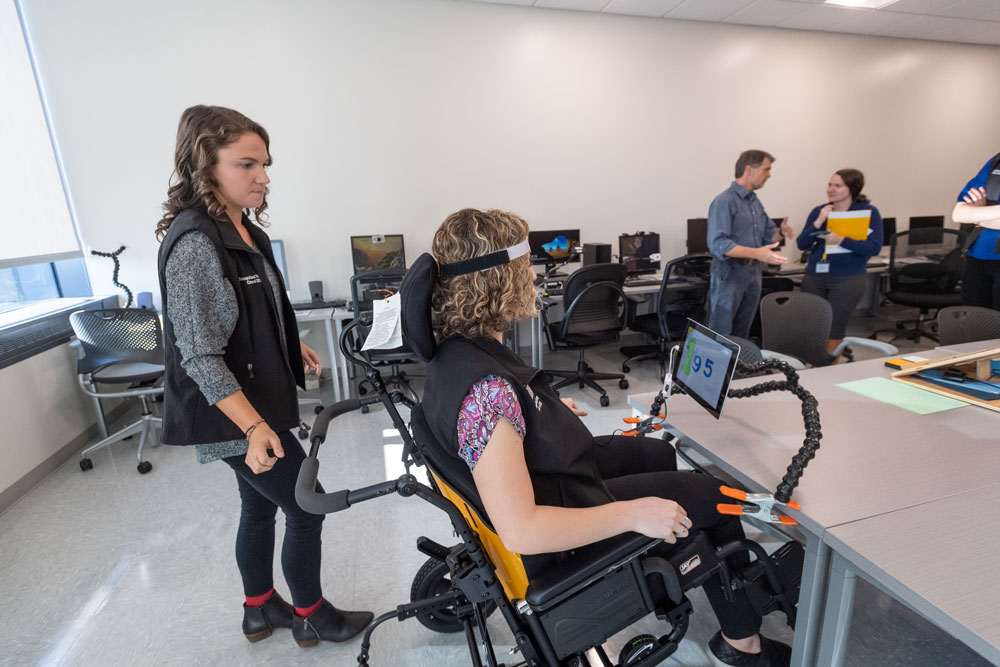 Student demonstrating assistive lab technology - by Tom Kojcsich at VCU Marketing