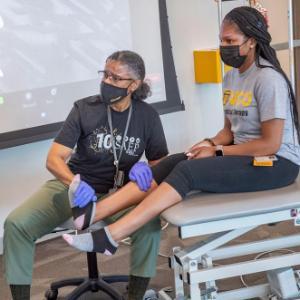 Cheryl Ford Smith demonstrates reflexology exam