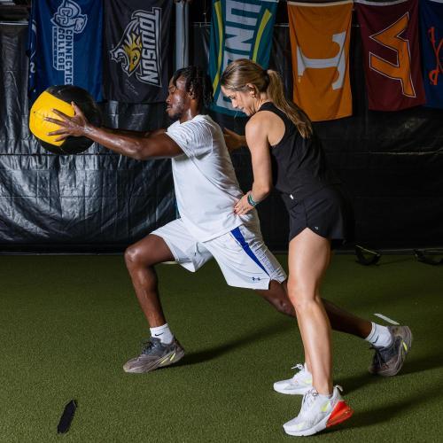 Gabby helping patient through physical therapy