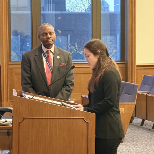 Ally Clark speaking at the podium with Delegate Thornton listening