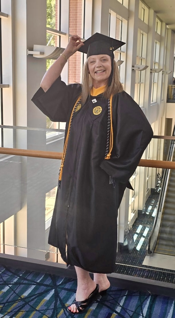 Graduate Angela Wiseman in graduation cap and cown