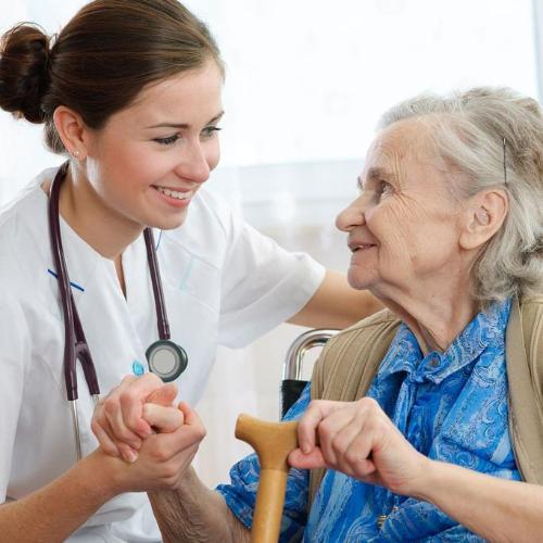 Medical professional helping elderly woman